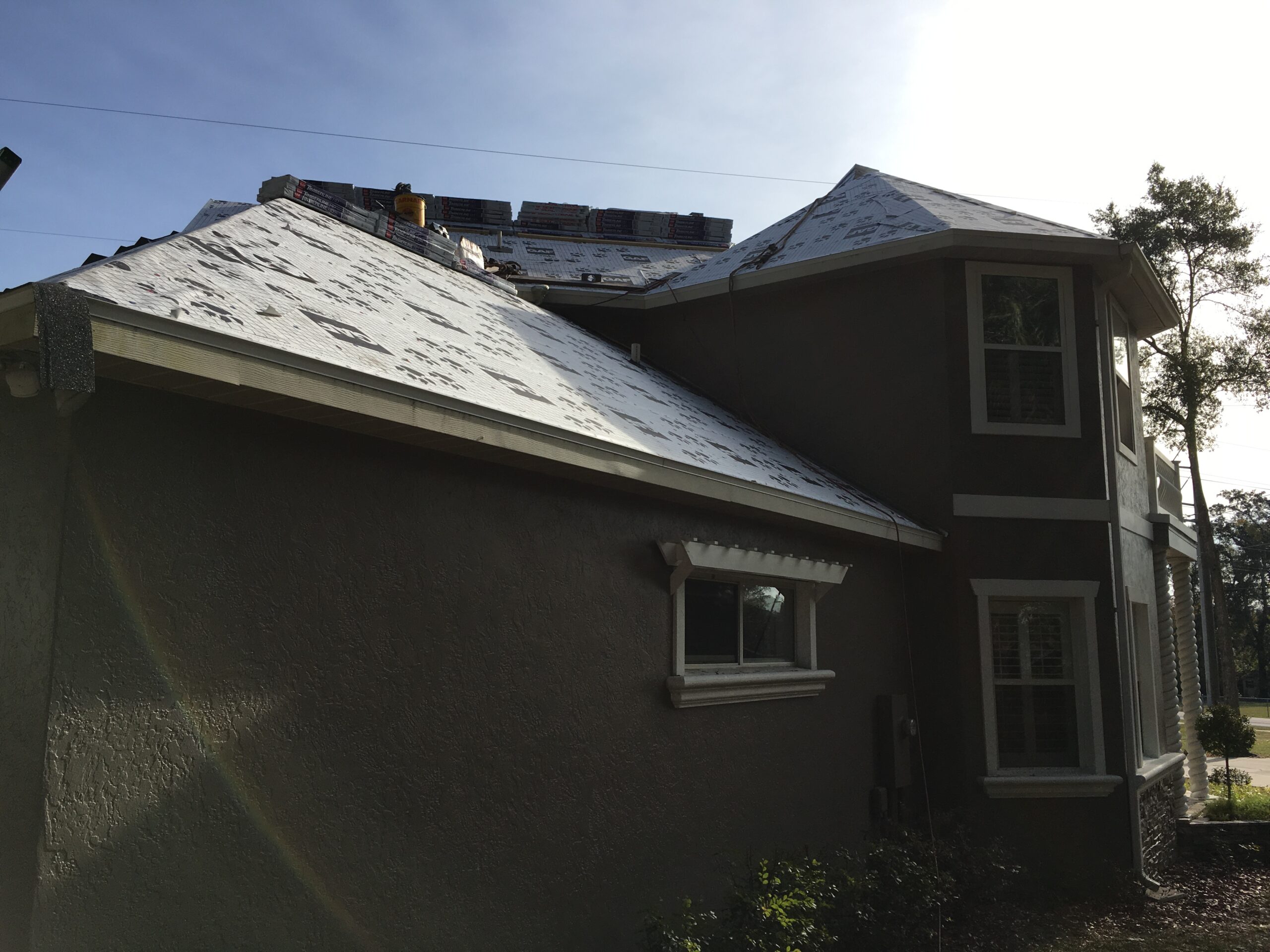Technician from United Roofing expertly assessing roof damage in Ocala, FL home